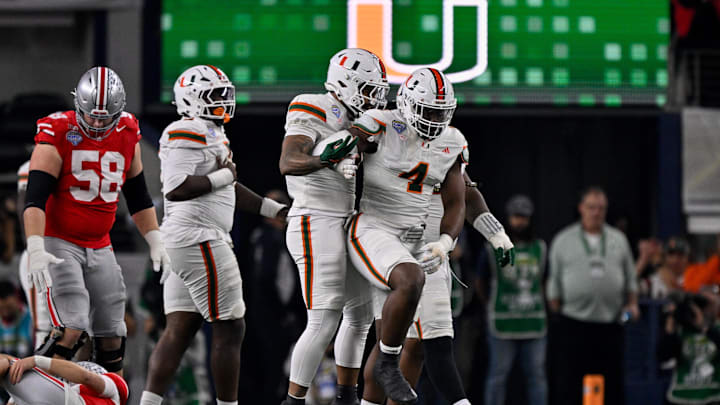 Dec 31, 2025; Arlington, TX, USA; Miami Hurricanes defensive lineman Rueben Bain Jr. (4) and defensive lineman Akheem Mesidor (3) celebrates after sacking Ohio State Buckeyes quarterback Julian Sayin (10) during the 2025 Cotton Bowl and quarterfinal game of the College Football Playoff at AT&T Stadium. Mandatory Credit: Jerome Miron-Imagn Images