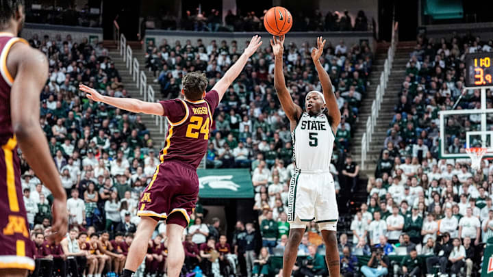 Michigan State guard Tre Holloman (5) makes a jump shot against Minnesota guard Brennan Rigsby (24) during the second half at Breslin Center in East Lansing on Tuesday, Jan. 28, 2025. Michigan State guard Tre Holloman (5) makes a jump shot against Minnesota guard Brennan Rigsby (24) during the second half at Breslin Center in East Lansing on Tuesday, Jan. 28, 2025.
