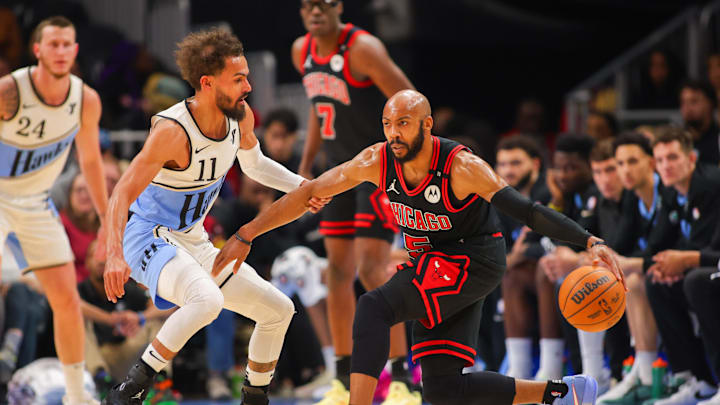 Dec 26, 2024; Atlanta, Georgia, USA; Atlanta Hawks guard Trae Young (11) defends Chicago Bulls guard Jevon Carter (5) in the first quarter at State Farm Arena. Mandatory Credit: Brett Davis-Imagn Images
