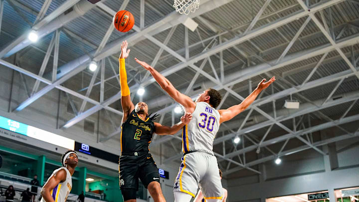 Oak Ridge Pioneers guard Jalen Reece (2) goes for a lay up as Montverde Academy Eagles guard Dante Allen (30) tries to block him during the first quarter of the City of Palms Classic semifinal game at Suncoast Credit Union Arena in Fort Myers, Fla., on Saturday, Dec. 21, 2024.