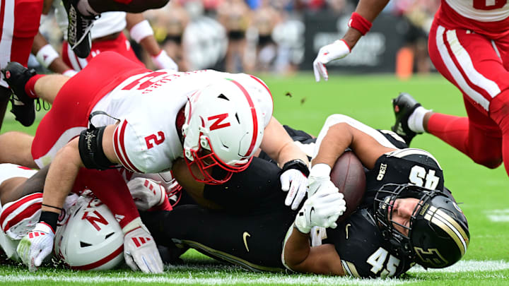 Sep 28, 2024; West Lafayette, Indiana, USA; Purdue Boilermakers running back Devin Mockobee (45) is tackled by Nebraska Cornhuskers defensive back Isaac Gifford (2) during the second quarter at Ross-Ade Stadium. Sep 28, 2024; West Lafayette, Indiana, USA; Purdue Boilermakers running back Devin Mockobee (45) is tackled by Nebraska Cornhuskers defensive back Isaac Gifford (2) during the second quarter at Ross-Ade Stadium.