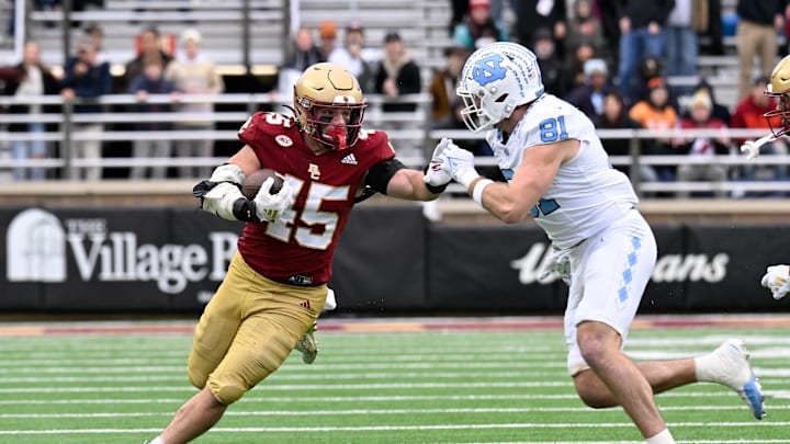 Nov 23, 2024; Chestnut Hill, Massachusetts, USA; Boston College Eagles linebacker Joe Marinaro (45) runs his interception back against North Carolina Tar Heels tight end John Copenhaver (81) during the first half at Alumni Stadium. Mandatory Credit: Eric Canha-Imagn Images Nov 23, 2024; Chestnut Hill, Massachusetts, USA; Boston College Eagles linebacker Joe Marinaro (45) runs his interception back against North Carolina Tar Heels tight end John Copenhaver (81) during the first half at Alumni Stadium. Mandatory Credit: Eric Canha-Imagn Images