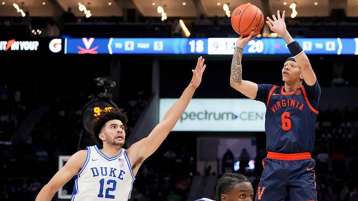 Mar 14, 2026; Charlotte, NC, USA; Virginia Cavaliers guard Jacari White (6) shoots over Duke Blue Devils forward Cameron Boozer (12) during the men's ACC Conference Tournament Championship at Spectrum Center. Mandatory Credit: Bob Donnan-Imagn Images Mar 14, 2026; Charlotte, NC, USA; Virginia Cavaliers guard Jacari White (6) shoots over Duke Blue Devils forward Cameron Boozer (12) during the men's ACC Conference Tournament Championship at Spectrum Center. Mandatory Credit: Bob Donnan-Imagn Images