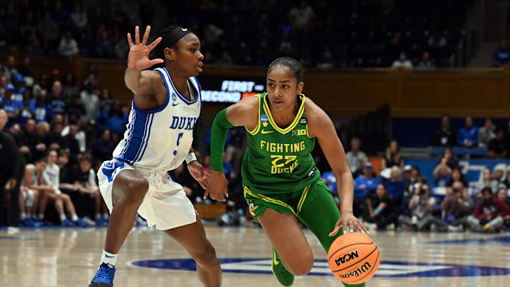 Mar 23, 2025; Durham, NC, USA; Oregon Ducks guard Deja Kelly (25) drives to the basket as Duke Blue Devils guard Oluchi Okananwa (5) defends during the second half at Cameron Indoor Stadium. The Blue Devils won 59-53. Mandatory Credit: Rob Kinnan-Imagn Images