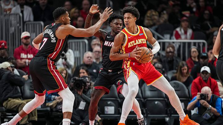Oct 28, 2026; Atlanta, Georgia, USA; Atlanta Hawks forward Jalen Johnson (1) is defended by Miami Heat forward Giannis Antetokounmpo (7) and guard Davion Mitchell (2) during the first half at State Farm Arena. Mandatory Credit: Dale Zanine-Imagn Images