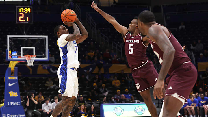 Dec 2, 2025; Pittsburgh, Pennsylvania, USA; Pittsburgh Panthers guard Damarco Minor (7) shoots a three point basket against Texas A&M Aggies guard Jacari Lane (5) during the first half at the Petersen Events Center. Mandatory Credit: Charles LeClaire-Imagn Images Dec 2, 2025; Pittsburgh, Pennsylvania, USA; Pittsburgh Panthers guard Damarco Minor (7) shoots a three point basket against Texas A&M Aggies guard Jacari Lane (5) during the first half at the Petersen Events Center. Mandatory Credit: Charles LeClaire-Imagn Images