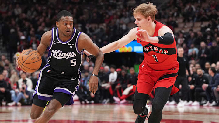 Mar 20, 2024; Toronto, Ontario, CAN; Sacramento Kings guard De'Aaron Fox (5) controls the ball as Toronto Raptors guard Gradey Dick (1) tries to defend during the first quarter at Scotiabank Arena. Mandatory Credit: Nick Turchiaro-Imagn Images