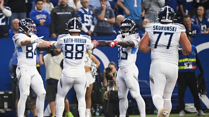 Oct 26, 2025; Indianapolis, Indiana, USA; Tennessee Titans tight end Gunnar Helm (84) celebrates with Tennessee Titans tight end Chig Okonkwo (85) and Tennessee Titans tight end David Martin-Robinson (88) after scoring a touchdown during the second quarter against the Indianapolis Colts at Lucas Oil Stadium. Mandatory Credit: Robert Goddin-Imagn Images Oct 26, 2025; Indianapolis, Indiana, USA; Tennessee Titans tight end Gunnar Helm (84) celebrates with Tennessee Titans tight end Chig Okonkwo (85) and Tennessee Titans tight end David Martin-Robinson (88) after scoring a touchdown during the second quarter against the Indianapolis Colts at Lucas Oil Stadium. Mandatory Credit: Robert Goddin-Imagn Images