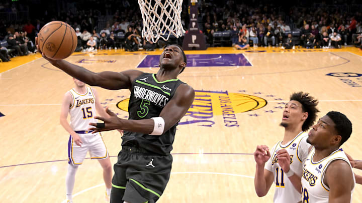 Apr 7, 2024; Los Angeles, California, USA;  Los Angeles Lakers forward Rui Hachimura (28) and guard Spencer Dinwiddie (26) look on as Minnesota Timberwolves guard Anthony Edwards (5) drives to the basket in the second half Crypto.com Arena. Mandatory Credit: Jayne Kamin-Oncea-Imagn Images