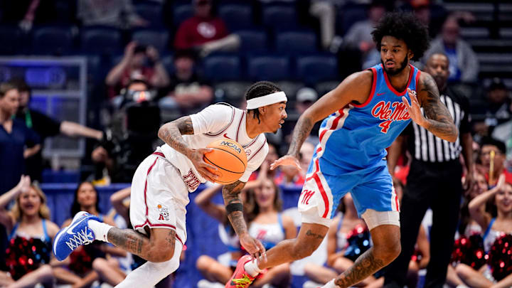 Alabama guard Labaron Philon (0) moves the ball past Mississippi forward James Scott (4) during the first half of a SEC tournament quarterfinal game at Bridgestone Arena in Nashville, Tenn., Friday, March 13, 2026.