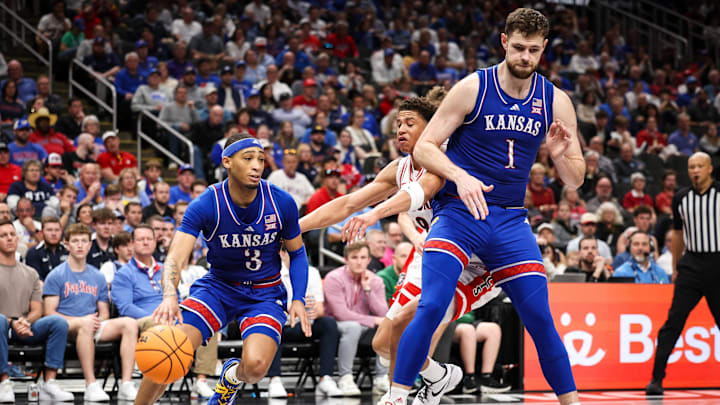 Mar 13, 2025; Kansas City, MO, USA; Kansas Jayhawks guard Dajuan Harris Jr. (3) drives to the basket during the second half against the Arizona Wildcats at T-Mobile Center. Mandatory Credit: William Purnell-Imagn Images Mar 13, 2025; Kansas City, MO, USA; Kansas Jayhawks guard Dajuan Harris Jr. (3) drives to the basket during the second half against the Arizona Wildcats at T-Mobile Center. Mandatory Credit: William Purnell-Imagn Images