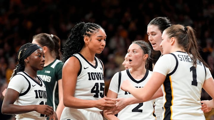 Iowa's Chit-Chat Wright (11), Hannah Stuelke (45), Taylor McCabe (2), Ava Heiden (5) and Taylor Stremlow (1) huddle during a game against the Michigan State Spartans Jan. 18, 2026 at Carver-Hawkeye Arena in Iowa City, Iowa.