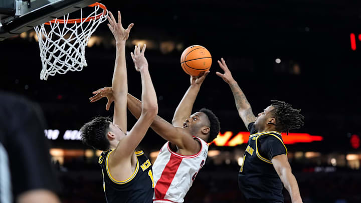 Michigan center Aday Mara and Michigan guard Roddy Gayle Jr. guard Arizona forward Tobe Awaka 