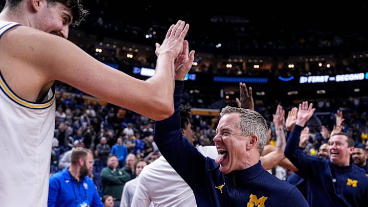 Michigan head coach Dusty May high-fives players after 95-72 win over Saint Louis at the NCAA Tournament Second Round at KeyBank Center in Buffalo on Saturday, March 21, 2026. Michigan head coach Dusty May high-fives players after 95-72 win over Saint Louis at the NCAA Tournament Second Round at KeyBank Center in Buffalo on Saturday, March 21, 2026.