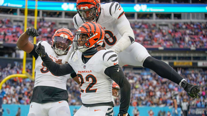 Cincinnati Bengals safety Geno Stone (22) celebrates his touchdown off of an interception against the Tennessee Titans during the third quarter at Nissan Stadium in Nashville, Tenn., Sunday, Dec. 15, 2024. Defensive tackle McKinnley Jackson (93) and defensive end Joseph Ossai (58) join in. Cincinnati Bengals safety Geno Stone (22) celebrates his touchdown off of an interception against the Tennessee Titans during the third quarter at Nissan Stadium in Nashville, Tenn., Sunday, Dec. 15, 2024. Defensive tackle McKinnley Jackson (93) and defensive end Joseph Ossai (58) join in.