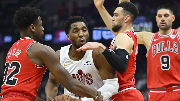 Cleveland Cavaliers guard Donovan Mitchell (45) drives between Chicago Bulls forward Terry Taylor (32) and guard Zach LaVine (8) in the second quarter at Rocket Mortgage FieldHouse. Mandatory Credit: David Richard-Imagn Images