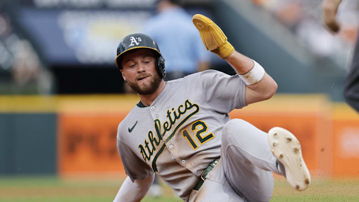 Jun 26, 2025; Detroit, Michigan, USA;  Athletics third base Max Schuemann (12) slides in safe at third in the third inning against the Detroit Tigers at Comerica Park. Mandatory Credit: Rick Osentoski-Imagn Images