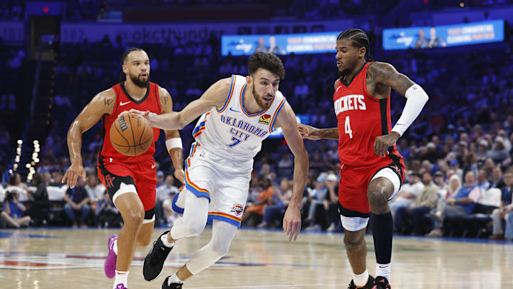 Oct 9, 2024; Oklahoma City, Oklahoma, USA; Oklahoma City Thunder forward Chet Holmgren (7) drives to the basket beside Houston Rockets guard Jalen Green (4) during the first quarter at Paycom Center. Mandatory Credit: Alonzo Adams-Imagn Images