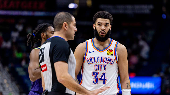 Oklahoma City Thunder forward Kenrich Williams discusses a play call with referee Mousa Dagher against New Orleans Pelicans guard Antonio Reevesduring the second half at Smoothie King Center. Mandatory Credit: Stephen Lew-Imagn Images