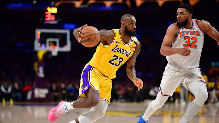 Los Angeles Lakers forward LeBron James moves to the basket against New York Knicks center Karl-Anthony Towns. Mandatory Credit: Gary A. Vasquez-Imagn Images
