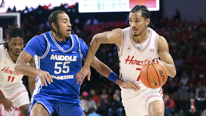 Dec 29, 2025; Houston, Texas, USA; Houston Cougars guard Milos Uzan (7) drives witht the ball as Middle Tennessee Blue Raiders guard Sean Smith (55) defends during the first half at Fertitta Center. Mandatory Credit: Troy Taormina-Imagn Images
