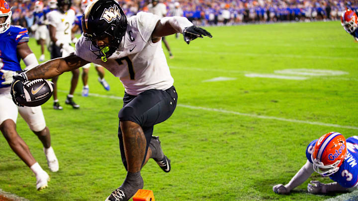 UCF Knights running back RJ Harvey (7) leaps over the pylon to score a touchdown during the second half at Ben Hill Griffin Stadium in Gainesville, FL on Saturday, October 5, 2024. UCF Knights running back RJ Harvey (7) leaps over the pylon to score a touchdown during the second half at Ben Hill Griffin Stadium in Gainesville, FL on Saturday, October 5, 2024.