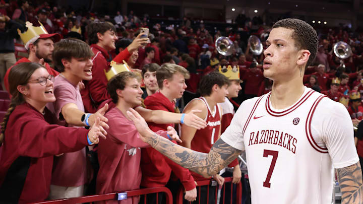 Jan 3, 2026; Fayetteville, Arkansas, USA; Arkansas Razorbacks forward Trevor Brazil (7) celebrates with the student section after the game against the Tennessee Volunteers at Bud Walton Arena.  Mandatory Credit: Nelson Chenault-Imagn Images