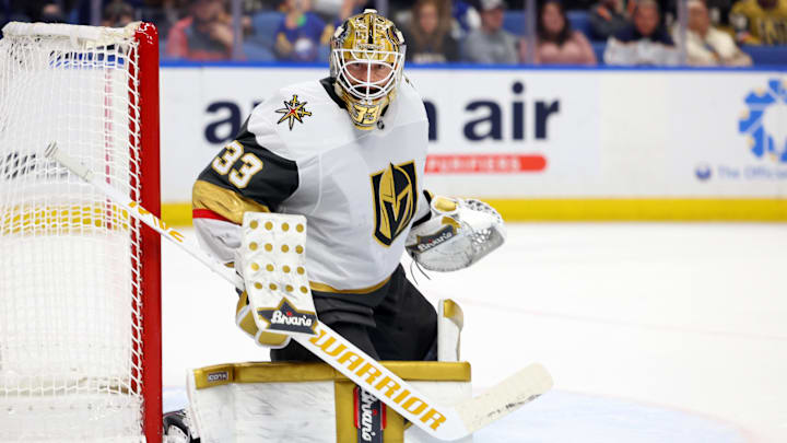 Mar 15, 2025; Buffalo, New York, USA;  Vegas Golden Knights goaltender Adin Hill (33) looks for the puck during the second period against the Buffalo Sabres at KeyBank Center. Mandatory Credit: Timothy T. Ludwig-Imagn Images