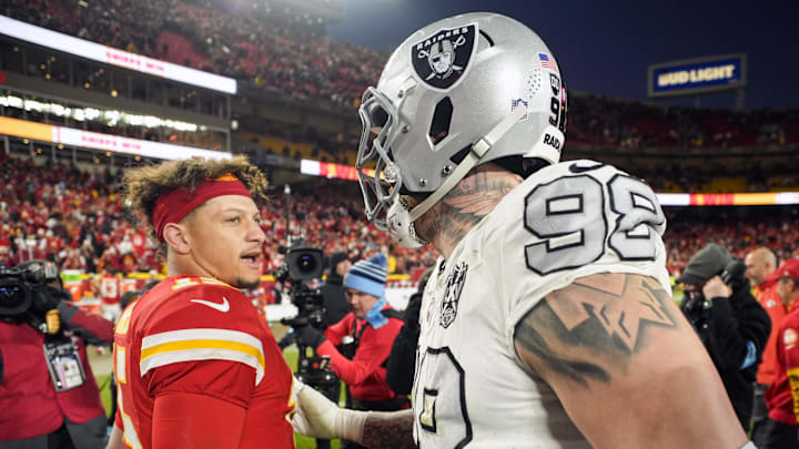 Nov 29, 2024; Kansas City, Missouri, USA; Kansas City Chiefs quarterback Patrick Mahomes (15) talks with Las Vegas Raiders defensive end Maxx Crosby (98) after a game at GEHA Field at Arrowhead Stadium. Mandatory Credit: Jay Biggerstaff-Imagn Images