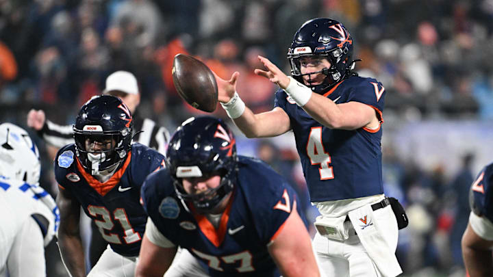 Dec 6, 2025; Charlotte, NC, USA; Virginia Cavaliers quarterback Chandler Morris (4) receives a snap in the third quarter against the Duke Blue Devils during the 2025 ACC Championship game at Bank of America Stadium. Mandatory Credit: Bob Donnan-Imagn Images Dec 6, 2025; Charlotte, NC, USA; Virginia Cavaliers quarterback Chandler Morris (4) receives a snap in the third quarter against the Duke Blue Devils during the 2025 ACC Championship game at Bank of America Stadium. Mandatory Credit: Bob Donnan-Imagn Images