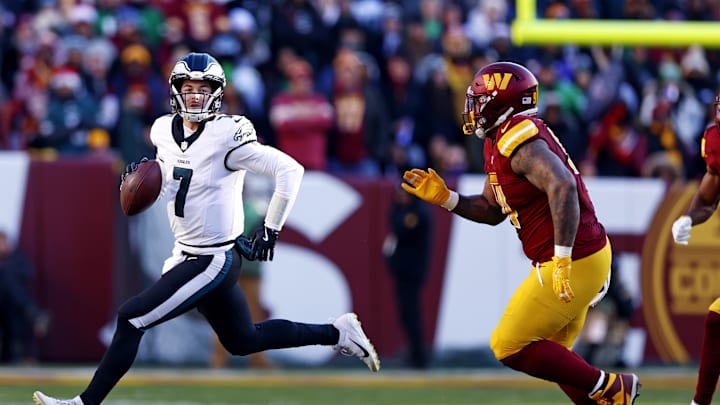 Dec 22, 2024; Landover, Maryland, USA; Philadelphia Eagles quarterback Kenny Pickett (7) runs the ball against Washington Commanders defensive tackle Daron Payne (94) during the second quarter at Northwest Stadium. Mandatory Credit: Peter Casey-Imagn Images