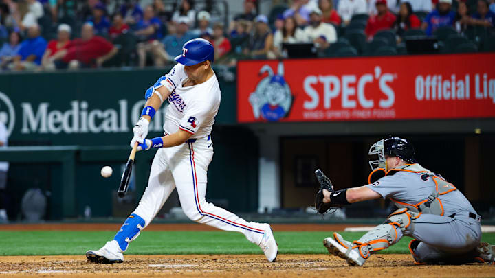 Jun 5, 2024; Arlington, Texas, USA;  Texas Rangers first base Nathaniel Lowe (30) hits an rbi single during the eighth inning against the Detroit Tigers at Globe Life Field.