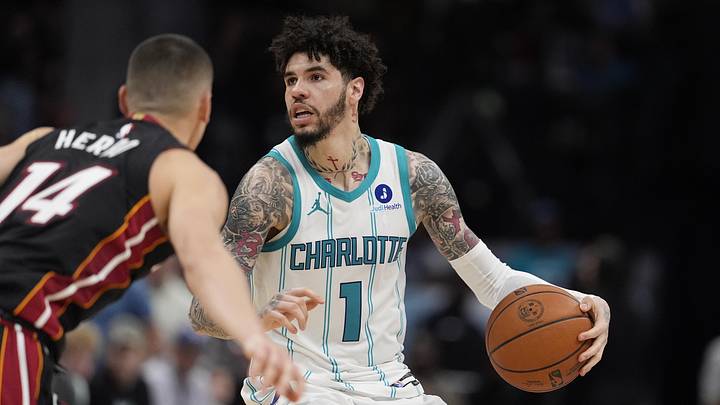Apr 14, 2026; Charlotte, North Carolina, USA; Charlotte Hornets guard LaMelo Ball (1) looks to pass defended by Miami Heat guard Tyler Herro (14) during the second half during the play-in rounds between the Charlotte Hornets and the Miami Heat of the 2026 NBA Playoffs at Spectrum Center. Mandatory Credit: Jim Dedmon-Imagn Images