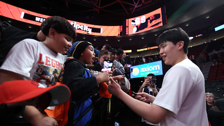 Oct 24, 2025; Portland, Oregon, USA; Portland Trail Blazers center Yang Hansen (16) gives away a pair of Li-Ning shoes to kids before Trail Blazers play Golden State Warriors Moda Center. Mandatory Credit: Jaime Valdez-Imagn Images Oct 24, 2025; Portland, Oregon, USA; Portland Trail Blazers center Yang Hansen (16) gives away a pair of Li-Ning shoes to kids before Trail Blazers play Golden State Warriors Moda Center. Mandatory Credit: Jaime Valdez-Imagn Images