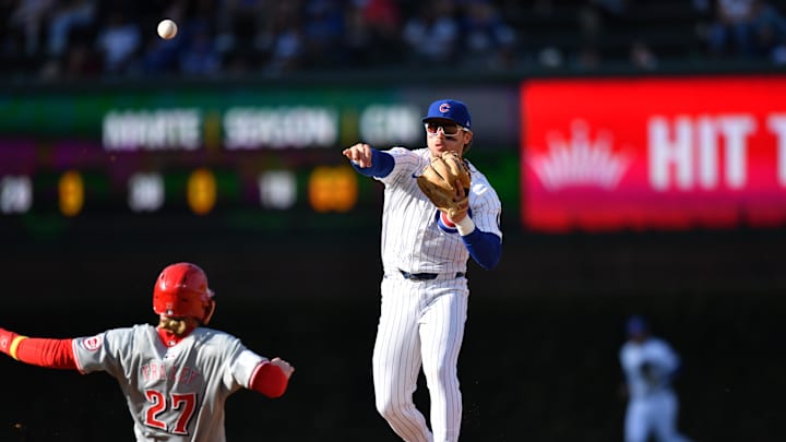 Chicago Cubs second base Nico Hoerner (2) completes a double play after forcing out Cincinnati Reds right fielder Jake Fraley (27) during the seventh inning at Wrigley Field on Sept 29.