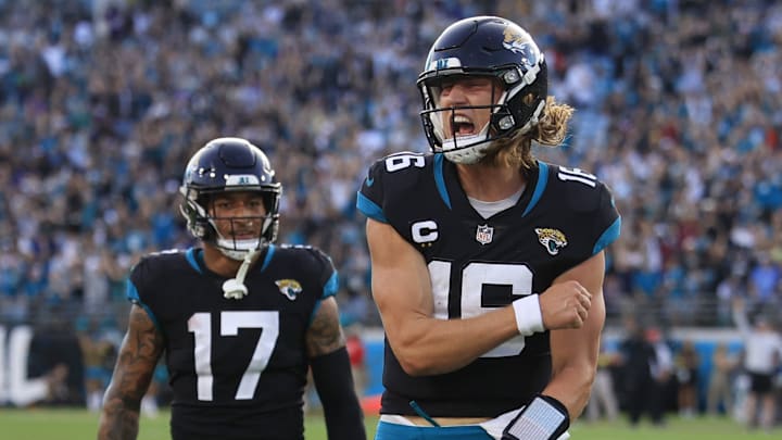 Jacksonville Jaguars quarterback Trevor Lawrence (16) reacts to his touchdown pass as teammate tight end Evan Engram (17) looks on during the fourth quarter of a regular season NFL football matchup Sunday, Nov. 27, 2022 at TIAA Bank Field in Jacksonville. The Jaguars edged the Ravens 28-27.