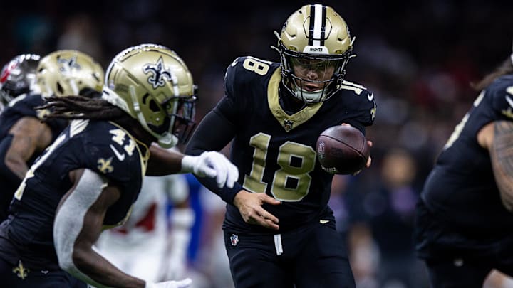 Oct 13, 2024; New Orleans, Louisiana, USA;  New Orleans Saints quarterback Spencer Rattler (18) hands off to running back Alvin Kamara (41) against the Tampa Bay Buccaneers during the second half at Caesars Superdome. 