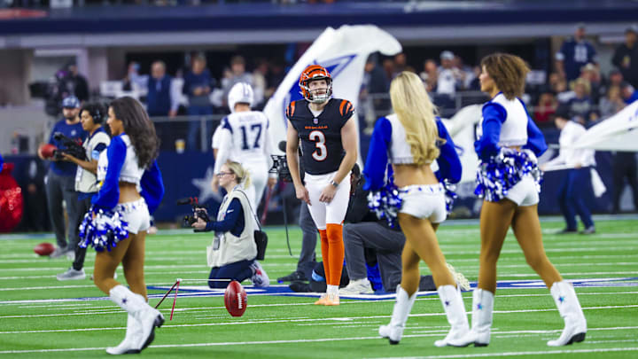 Dec 9, 2024; Arlington, Texas, USA;  Cincinnati Bengals kicker Cade York (3) warms up in front of the Dallas Cowboys Cheerleaders before the game.