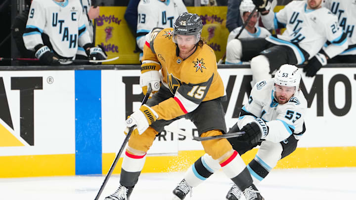 Apr 19, 2026; Las Vegas, Nevada, USA; Vegas Golden Knights defenseman Noah Hanifin (15) skates the puck away from Utah Mammoth left wing Michael Carcone (53) during the second period of game one of the first round of the 2026 Stanley Cup Playoffs at T-Mobile Arena. Mandatory Credit: Stephen R. Sylvanie-Imagn Images