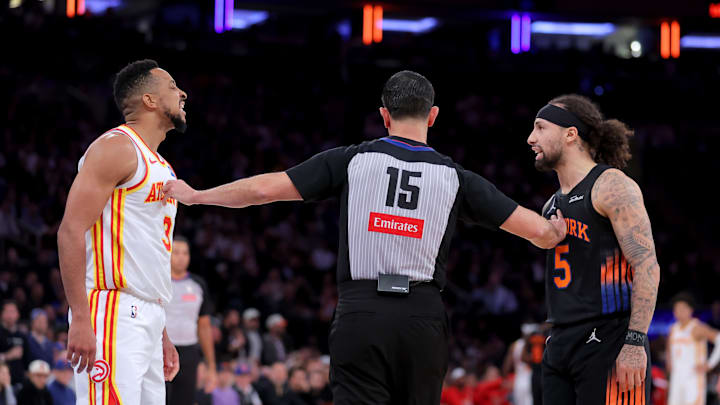 Apr 20, 2026; New York, New York, USA; Atlanta Hawks guard CJ McCollum (3) and New York Knicks guard Jose Alvarado (5) exchange words while separated by referee Zach Zarba (15) during the third quarter of game two of the first round of the 2026 NBA Playoffs at Madison Square Garden. Mandatory Credit: Brad Penner-Imagn Images