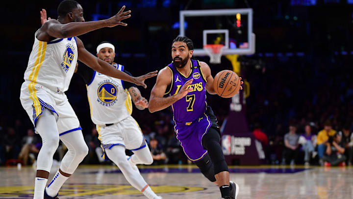 Feb 6, 2025; Los Angeles, California, USA; Los Angeles Lakers guard Gabe Vincent (7) moves the ball against Golden State Warriors forward Draymond Green (23) and guard Gary Payton II (0) during the first half at Crypto.com Arena. Mandatory Credit: Gary A. Vasquez-Imagn Images Feb 6, 2025; Los Angeles, California, USA; Los Angeles Lakers guard Gabe Vincent (7) moves the ball against Golden State Warriors forward Draymond Green (23) and guard Gary Payton II (0) during the first half at Crypto.com Arena. Mandatory Credit: Gary A. Vasquez-Imagn Images