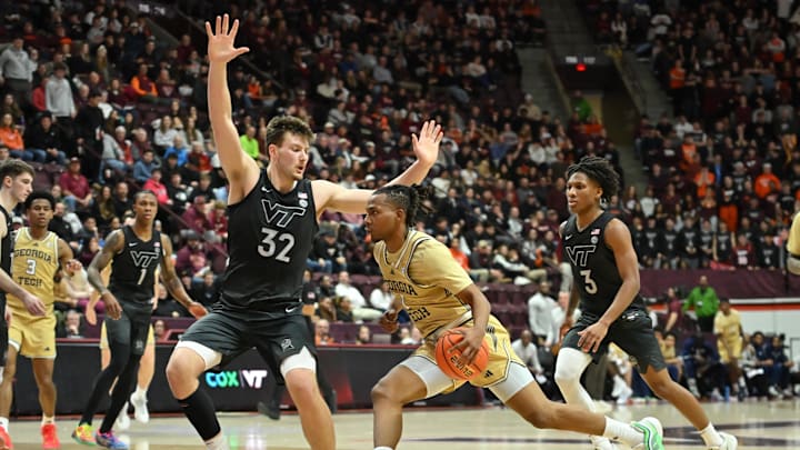 Jan 27, 2026; Blacksburg, Virginia, USA; Georgia Tech Yellow Jackets guard Lamar Washington (1) drives toward the basket as Virginia Tech Hokies center Christian Gurdak (32) defends during the first half at Cassell Coliseum. Mandatory Credit: Brian Bishop-Imagn Images