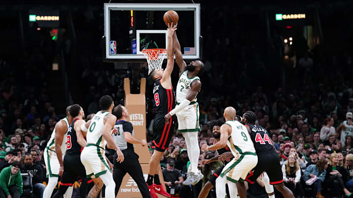 Nov 28, 2023; Boston, Massachusetts, USA; Boston Celtics guard Jaylen Brown (7) and Chicago Bulls center Nikola Vucevic (9) for a jump ball in the second half at TD Garden. Mandatory Credit: David Butler II-Imagn Images