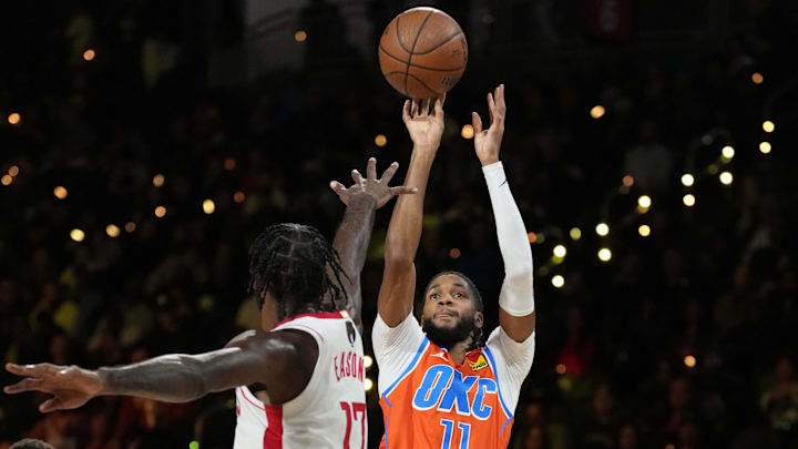 Dec 14, 2024; Las Vegas, Nevada, USA; Oklahoma City Thunder guard Isaiah Joe (11) shoots against Houston Rockets forward Tari Eason (17) during the first half in a semifinal of the 2024 Emirates NBA Cup at T-Mobile Arena. Mandatory Credit: Kyle Terada-Imagn Images