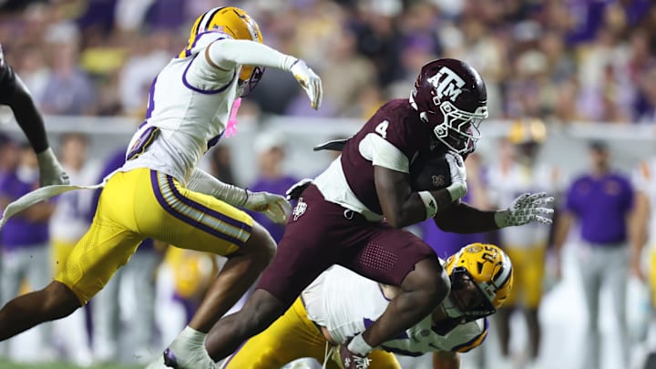 Oct 25, 2025; Baton Rouge, Louisiana, USA; Texas A&M Aggies running back Rueben Owens II (4) runs against Louisiana State Tigers cornerback Mansoor Delane (4) and defensive end Jack Pyburn (44) during the second half at Tiger Stadium. Mandatory Credit: Stephen Lew-Imagn Images