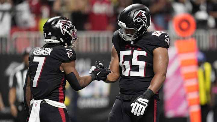 Atlanta Falcons running back Bijan Robinson celebrates with guard Matthew Bergeron 