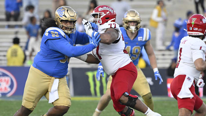 Nov 30, 2024; Pasadena, California, USA; UCLA Bruins defensive lineman Jay Toia (93) fights off a block by Fresno State Bulldogs offensive lineman Toreon Penright (77) to pressure quarterback Mikey Keene (1) during the fourth quarter at Rose Bowl. Mandatory Credit: Robert Hanashiro-Imagn Images