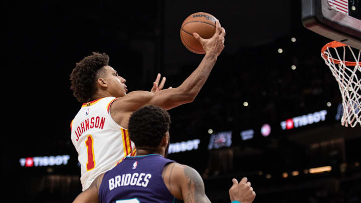 Oct 25, 2024; Atlanta, Georgia, USA; Atlanta Hawks forward Jalen Johnson (1) jumps for the basket against Charlotte Hornets forward Miles Bridges (0) during the fourth quarter at State Farm Arena. Mandatory Credit: Jordan Godfree-Imagn Images