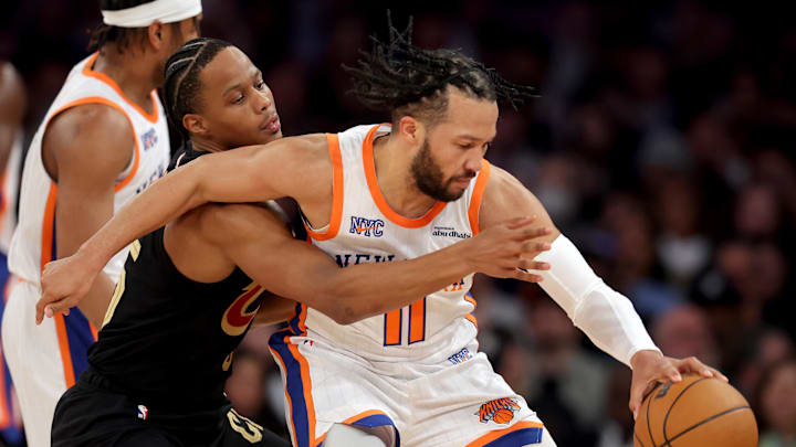 Cleveland Cavaliers forward Isaac Okoro reaches for the ball against New York Knicks guard Jalen Brunson. Mandatory Credit: Brad Penner-Imagn Images
