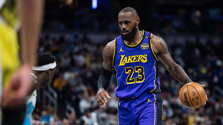Mar 26, 2025; Indianapolis, Indiana, USA; Los Angeles Lakers forward LeBron James (23) dribbles the ball while  Indiana Pacers forward Pascal Siakam (43) defends in the second half at Gainbridge Fieldhouse. Mandatory Credit: Trevor Ruszkowski-Imagn Images